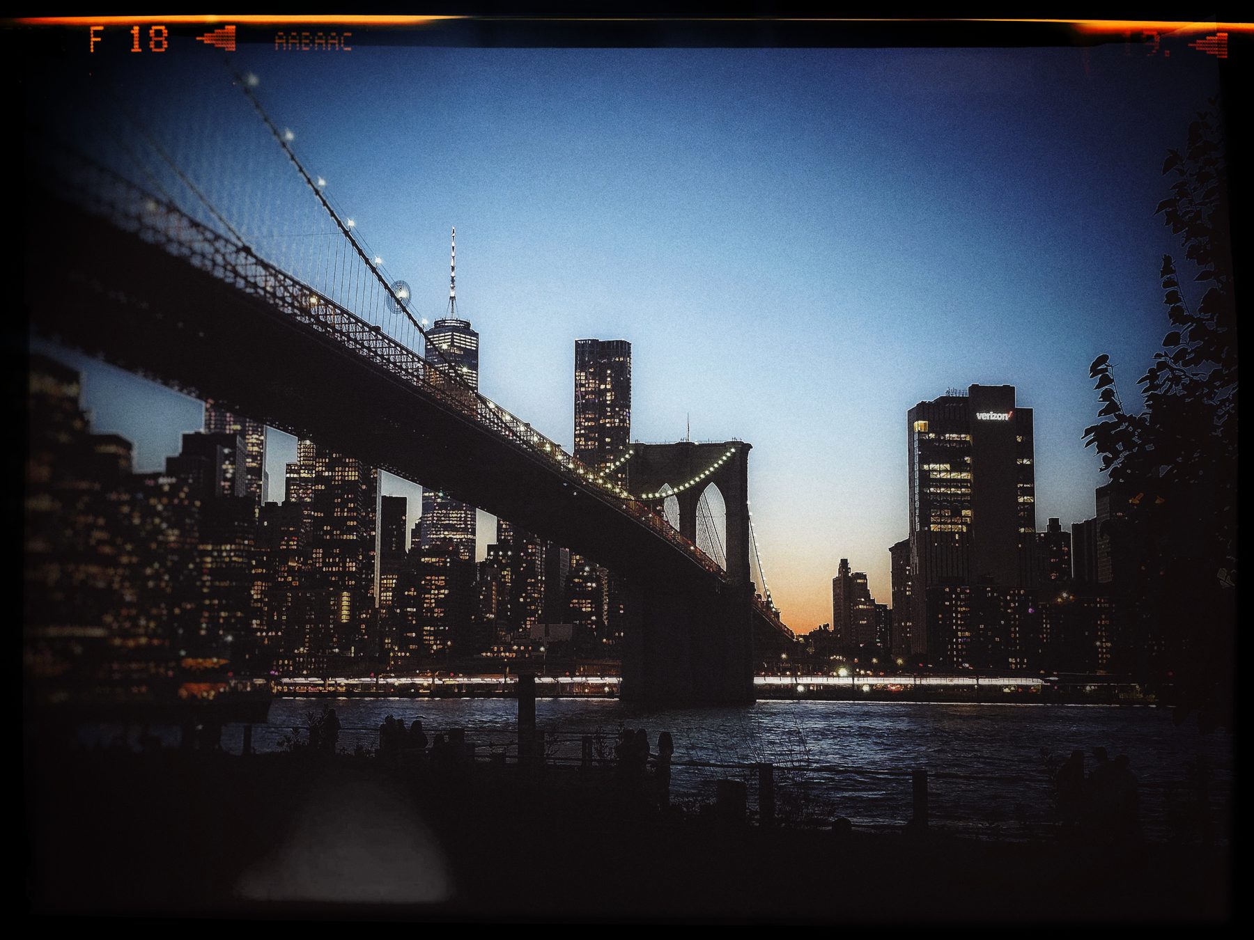 The Brooklyn Bridge at blue hour with the lit Manhattan skyline behind it